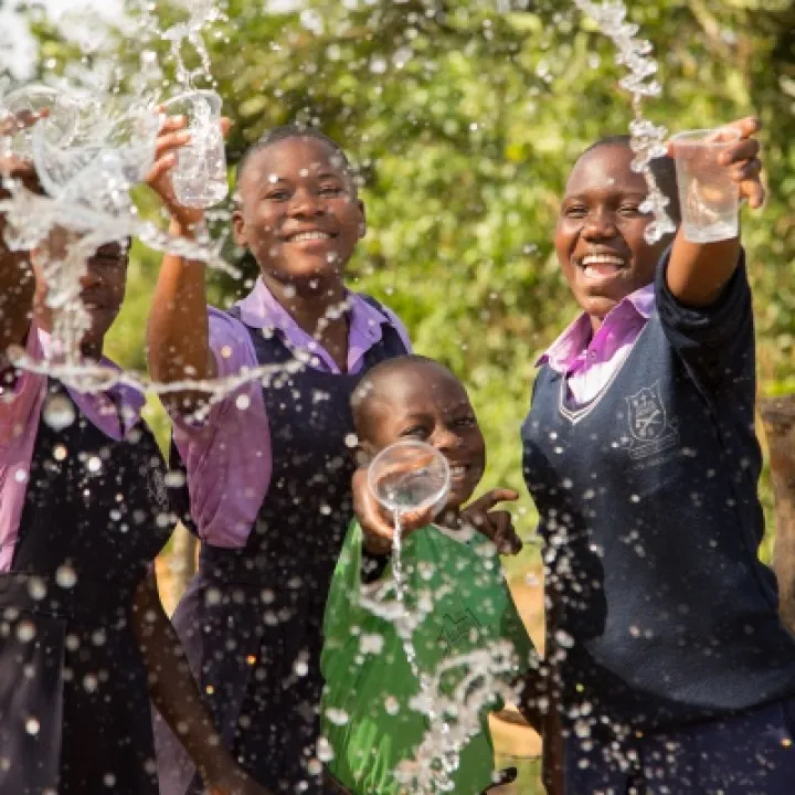 Members of St Balikddembe schools health club (SHC) enjoying the new water source &ndash; Copyright All We Can