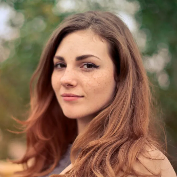 Closeup Photo of Woman With Brown Coat and Gray Top