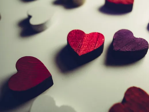 Vibrant wooden heart shapes in red and purple