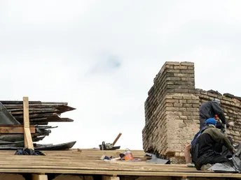 Repair of a wooden roof and an old brick chimney pipe Worker