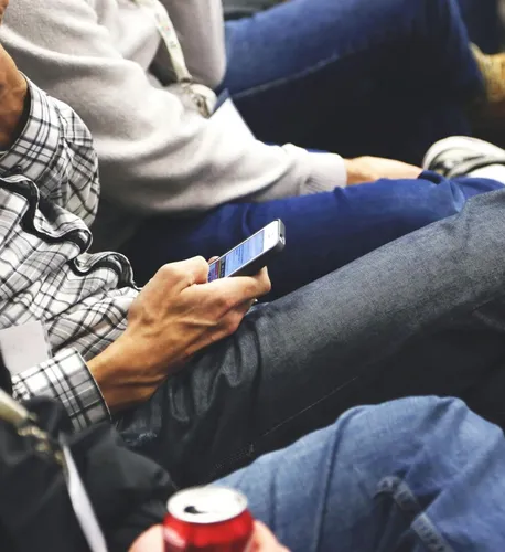 People sitting at a conference casually checking