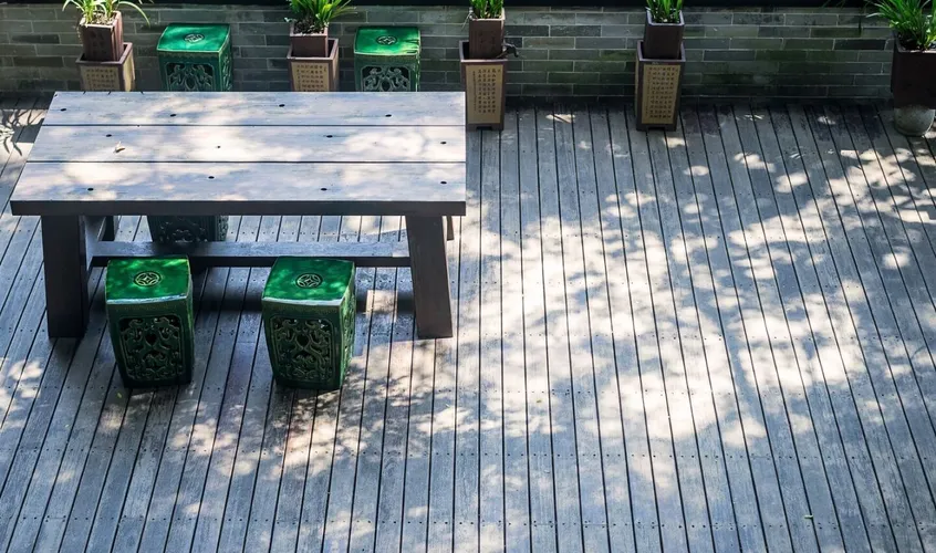 Terrace with a wooden table and plants