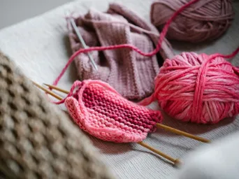 From above of knitted piece with bright pink yarn