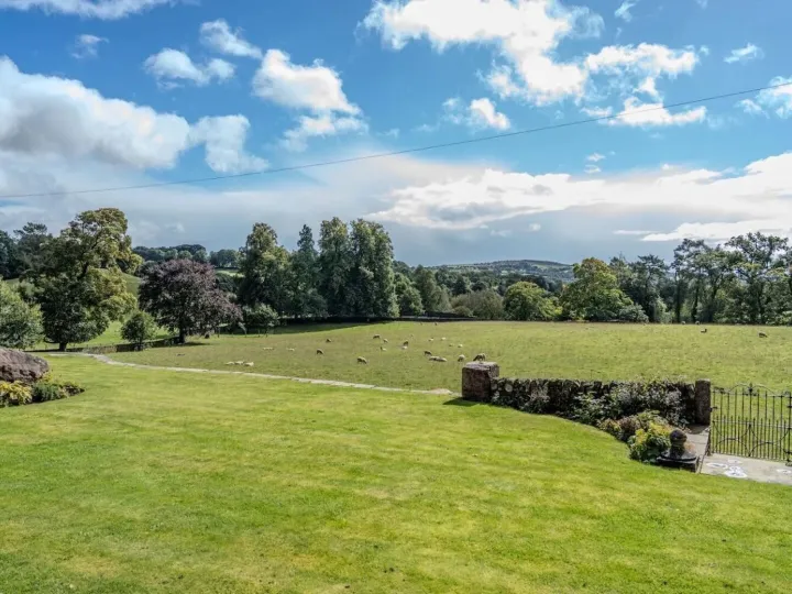 View across the lawn and sheep pasture to the hills of the Dane valley