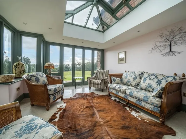 The conservatory with roof lantern and views over the gardens
