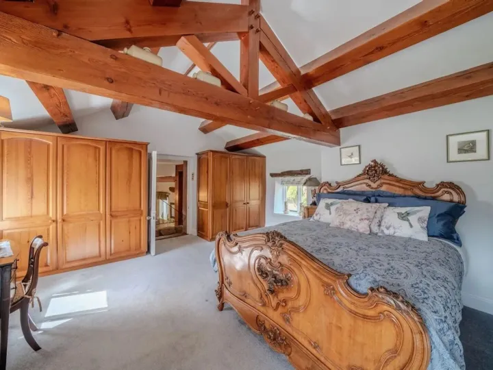 Bedroom one, a beamed room with a large French bed