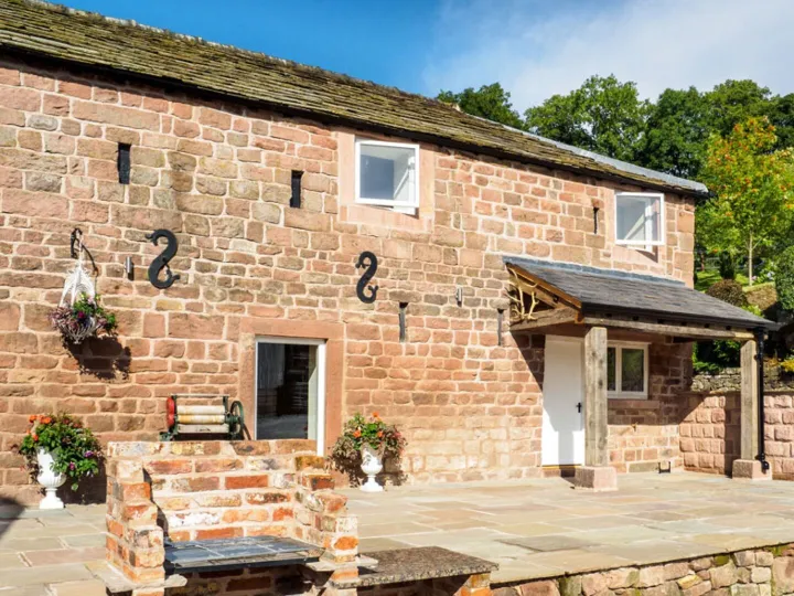 The patio and brick built barbecue outside Otters Retreat holiday cottage