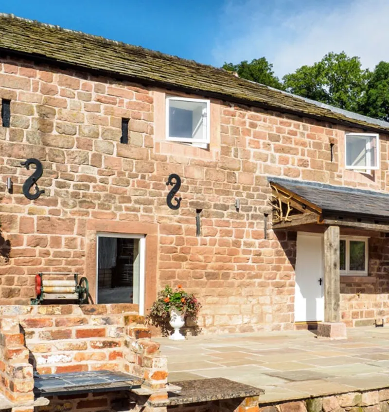 The patio and brick built barbecue outside Otters Retreat holiday cottage