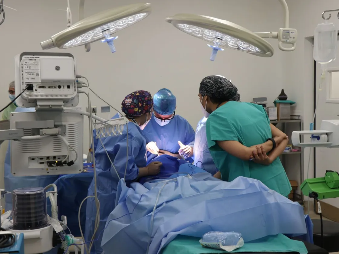 Surgical team operating under theatre lights