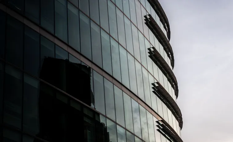 Contemporary glass office building in London reflecting the cityscape