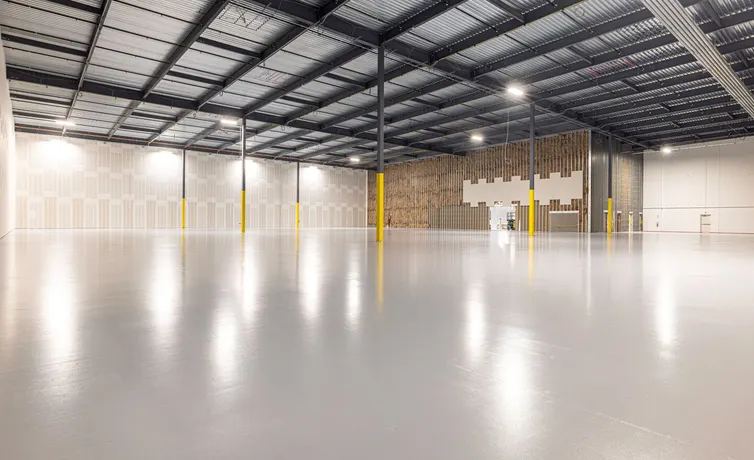 Empty modern warehouse interior with polished concrete floor