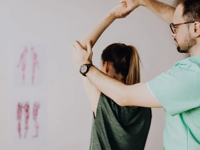 Physiotherapist assessing a client's arm and shoulder