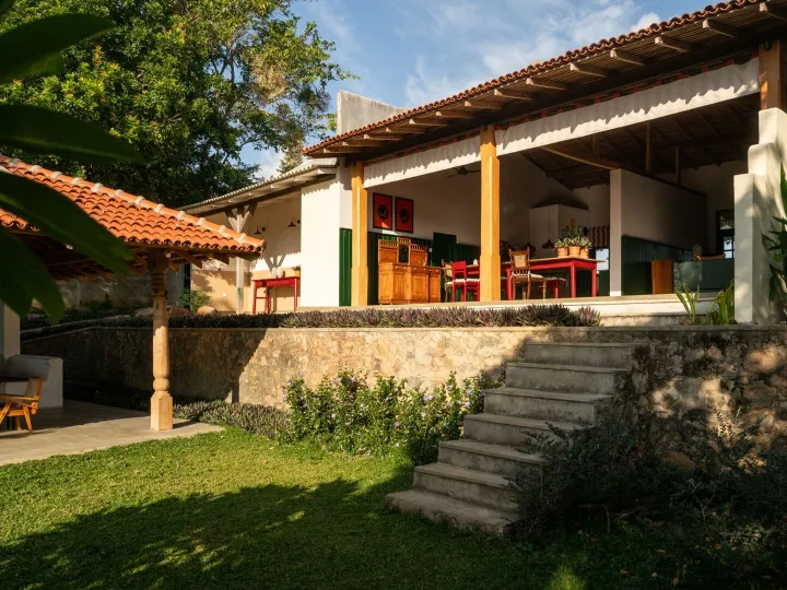 The villa and its lawn steps seen from the lake side garden at Peacock Hill Sigiriya