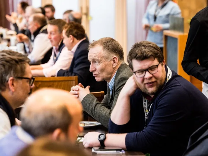 Delegates in discussion around a table