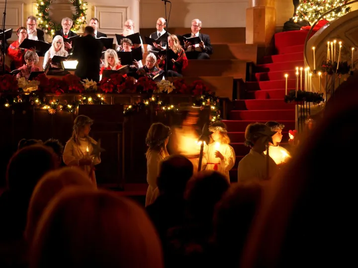 Choir and children with candles at a Christmas carol service
