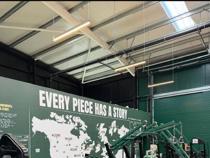 Green painted feature wall with a large world map mural behind rows of strength training machines