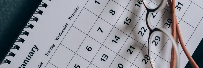 Brown-Framed Eyeglasses on a Calendar