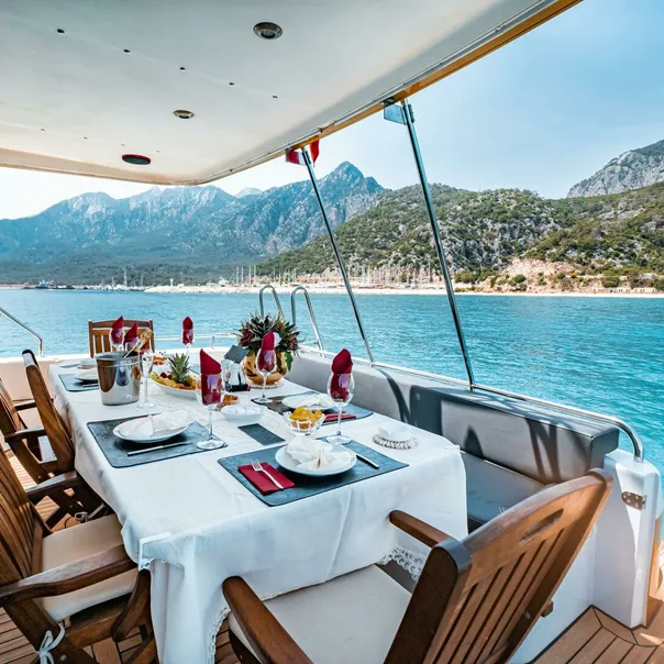 Elegant dining setup on a yacht overlooking Antalya's scenic coast in Türkiye.