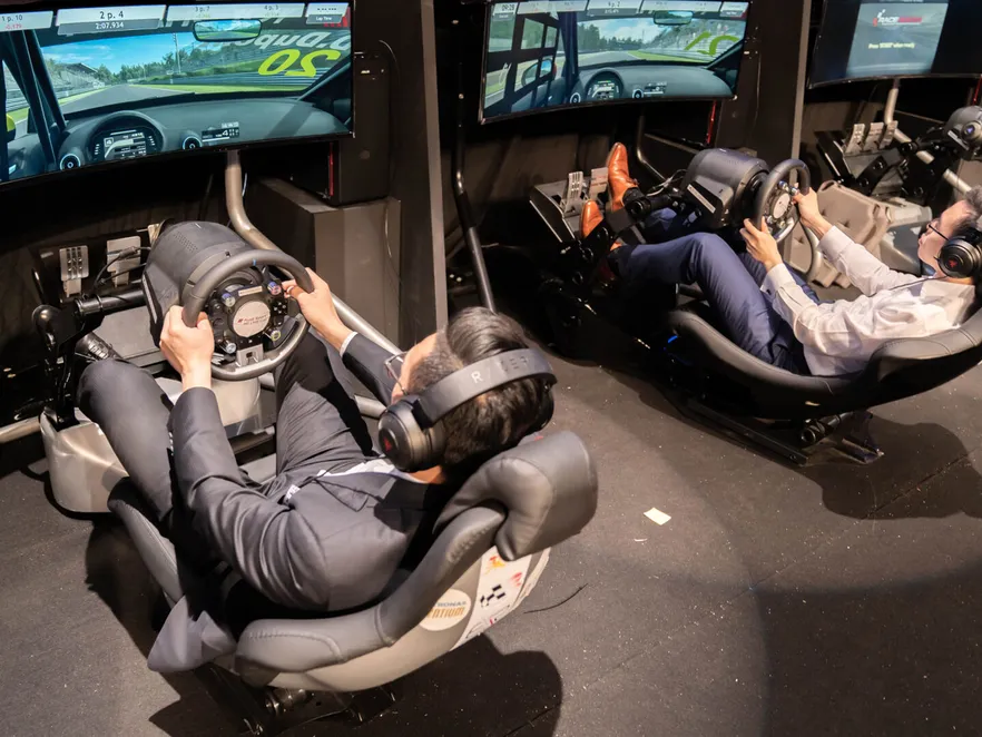 Two drivers in racing simulator rigs