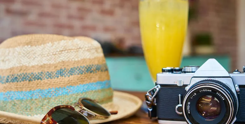 A stylish scene showcasing a vintage camera, hat