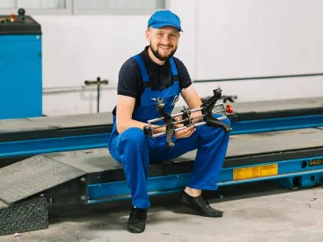 Technician with car detail at garage