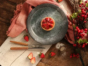 A delicious strawberry tart dusted with powdered