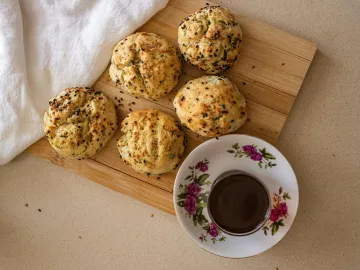 Enjoy a warm cup of tea paired with homemade scones, perfect for a cozy afternoon break.