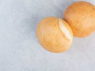 Round burger buns on stone surface