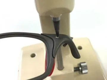 Sunglasses repair tool in operation