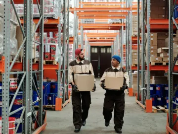 Warehouse Workers Carrying Boxes