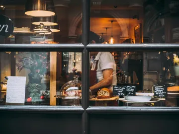 Warm bakery scene in London through window showcas
