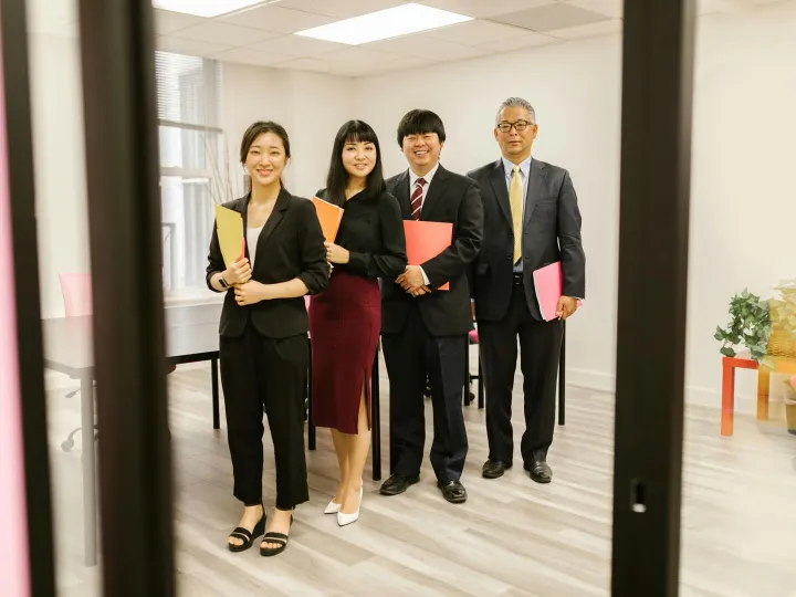 A diverse group of professionals smiling in a mode