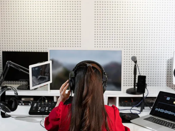 Woman working at a radio station with special equipment