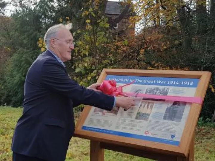 cutting ribbon on panel