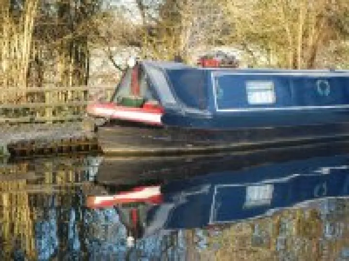 Canal boat reflection on Autumn morning