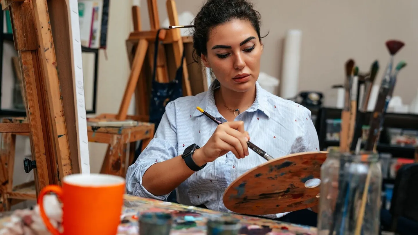 Young artist working on a painting at the studio
